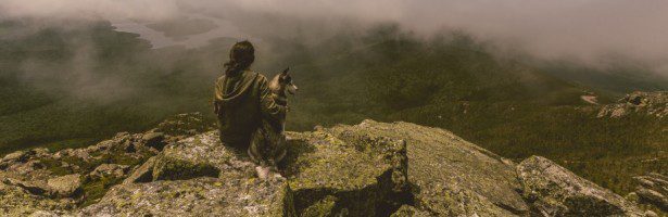 A woman sitting on a rock asking herself, Why Get an MBA?