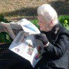 A man reading a newspaper at the ted rogers school