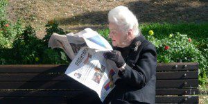 A man reading a newspaper at the ted rogers school