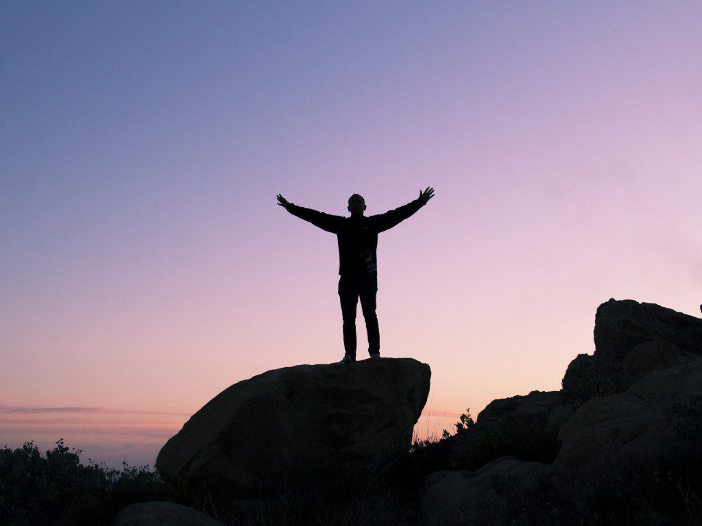 A man standing on top of a rock