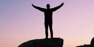 A man standing on top of a rock