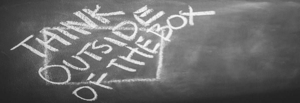 think outside the box written on chalkboard