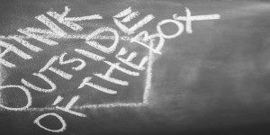 think outside the box written on chalkboard