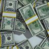pile of money meant to symbolize the rising MBA student debt